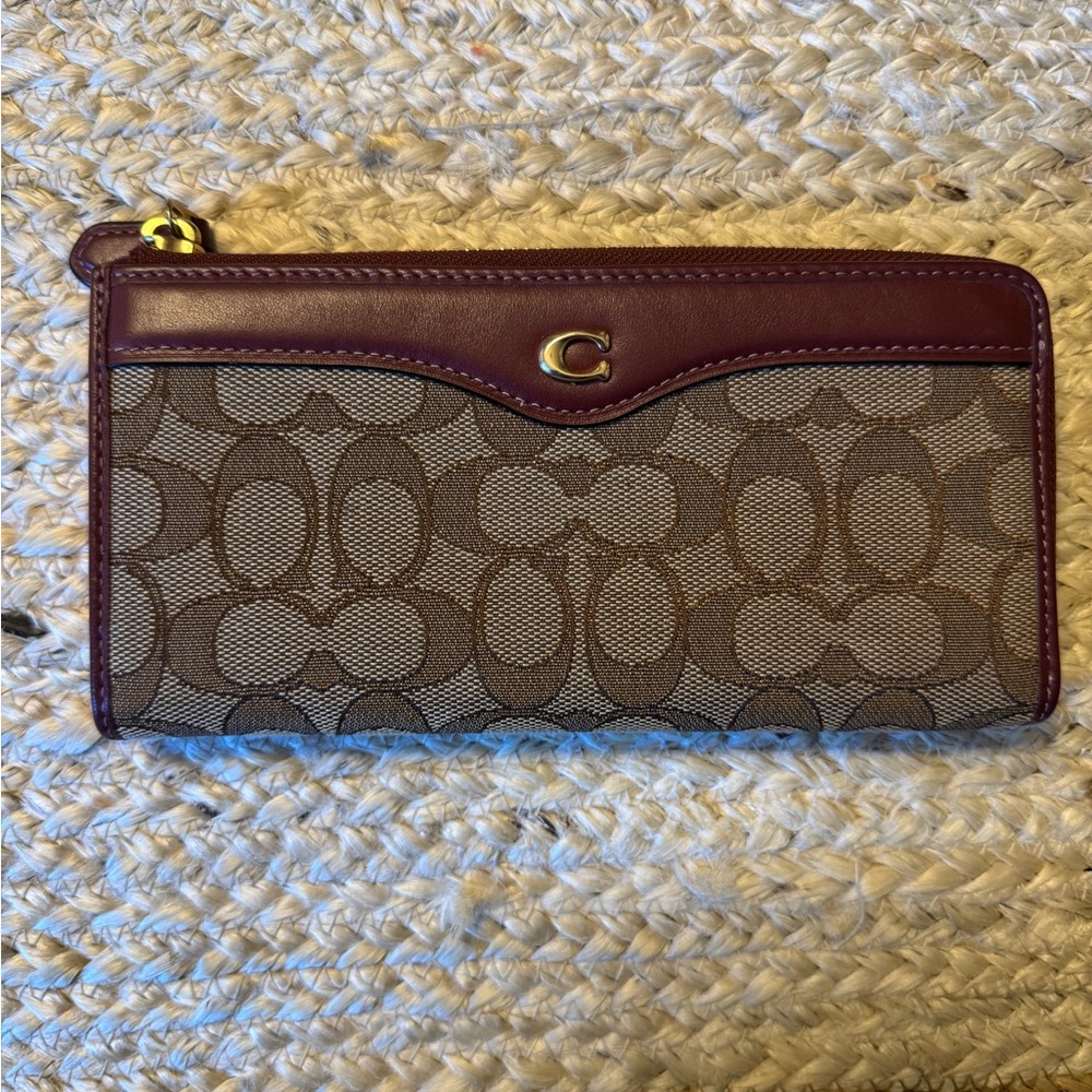 Coach Zip Around Wallet with brown signature canvas and burgundy leather trim